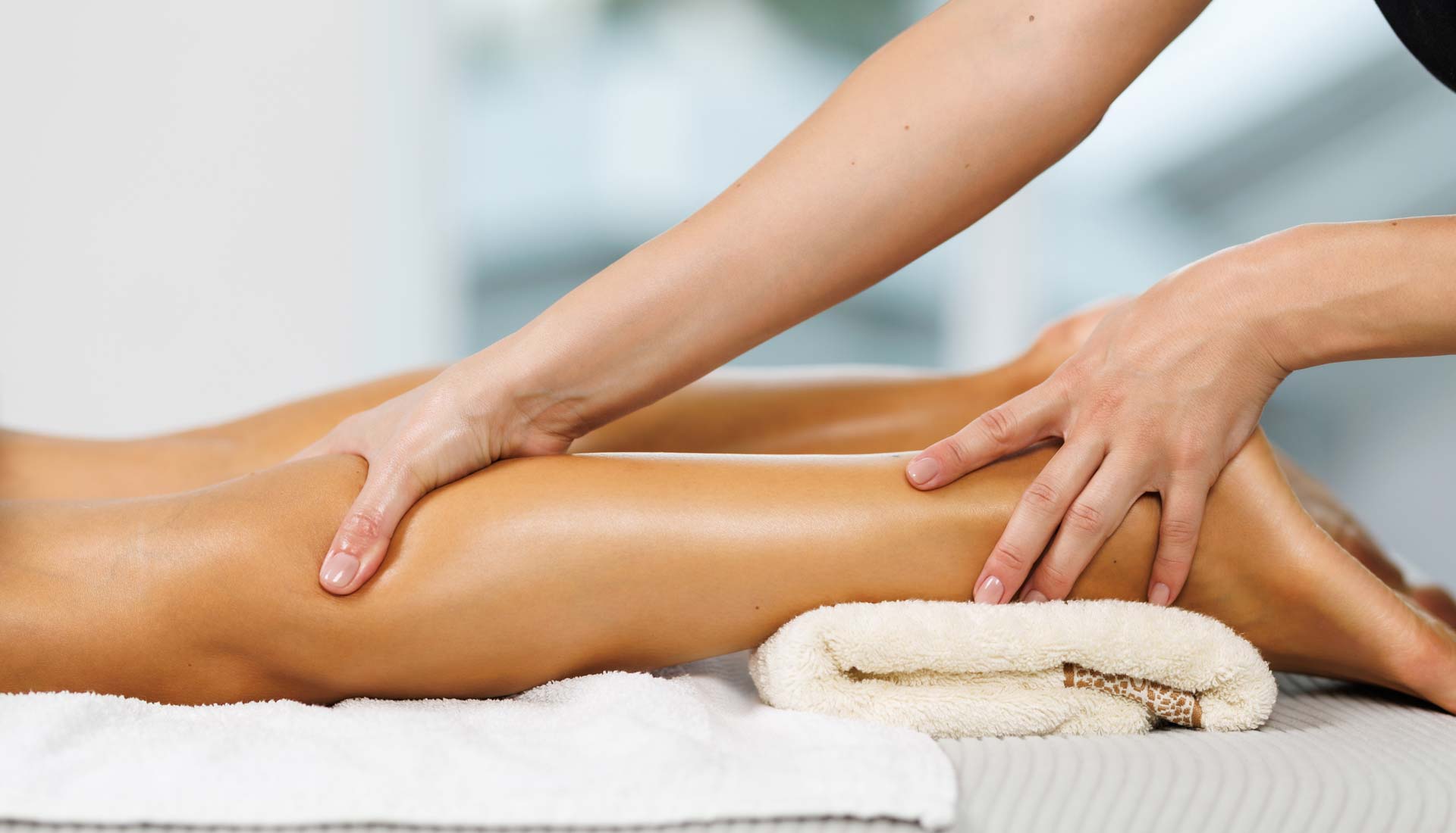 Therapist performing Decongestive Lymphatic Therapy on a patient's leg to help reduce lymphoedema swelling.